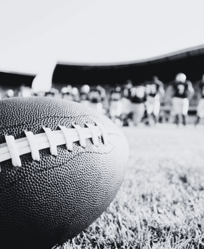 Vintage image of a football team on the field from the view behind the football